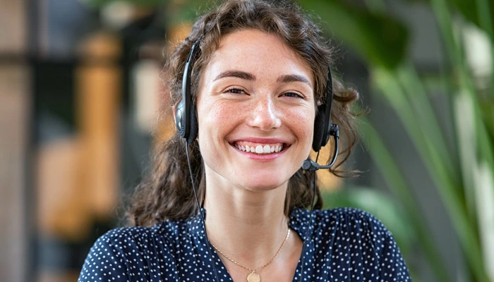 Smiling customer support representative wearing a headset, ready to assist with ignition interlock questions