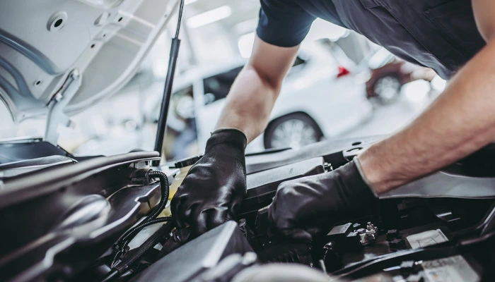 Mechanic under the hood of a car