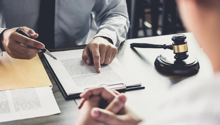 Legal professional discussing ignition interlock device requirements with a client at a desk